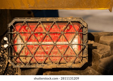Dirty Muddy Tail Light of Construction Vehicle with Protective Grille