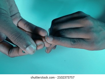 Dirty Nails With Black Droppings. A Girl Removing Dirt From Under Her Fingernails With A Sharp Object. A Girl In Need Of Hygiene And Bad Manicure.