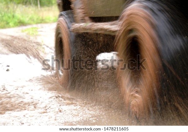 dirty\
off-road car in the forest and through\
puddles