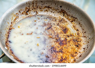 Dirty Oily Pan With Cold Solid Grease Saturated Fat From Bacon After Frying Macro Closeup As Unhealthy Leftover Cleaning Job