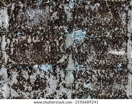 Dirty old eroded cracked plaster cement block fence. Concrete block wall. Destroyed crumbling cement mortar texture. Background of wall. Brick texture with scratches and cracks. brick wall background