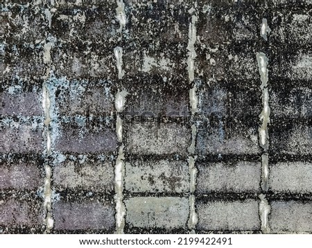 Dirty old eroded cracked plaster cement block fence. Concrete block wall. Destroyed crumbling cement mortar texture. Background of wall. Brick texture with scratches and cracks. brick wall background