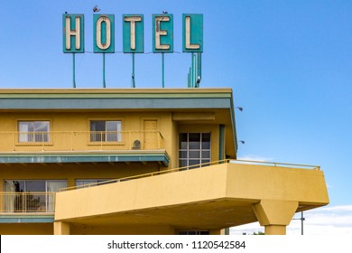 Dirty old hotel sign on the top of a highway motel in an American city - Powered by Shutterstock