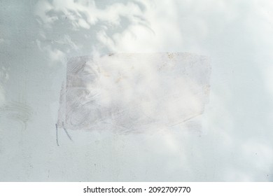 Dirty plastered wall with painted rectangular spot and shadow. Light texture, peeling plaster. Abstract background