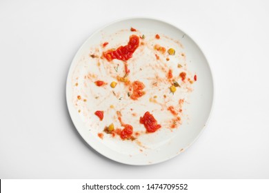 Dirty Plate With Food Leftovers On White Background, Top View