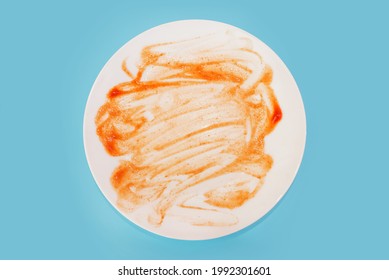 dirty plate isolated on blue background. View from above. Close-up. - Shutterstock ID 1992301601