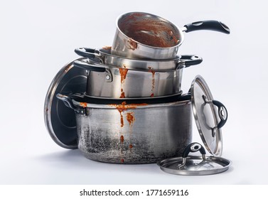 

Dirty pots and lids stacked together on a white background. - Shutterstock ID 1771659116
