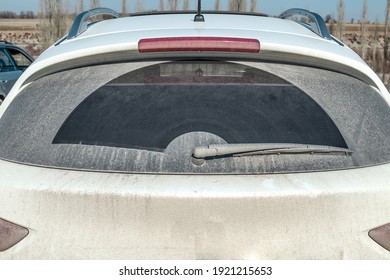 Dirty Rear Window Of A Car Close-up.