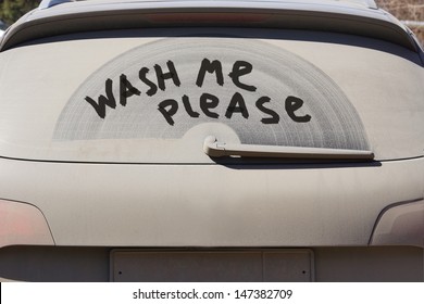 Dirty Rear Window Of The Car And Inscription Wash Me Please