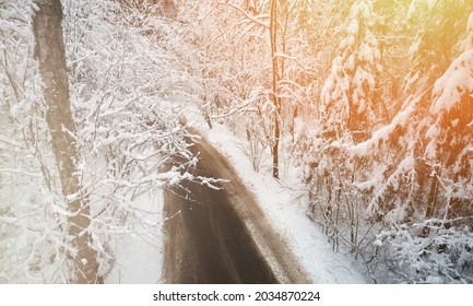 Dirty Road In White Winter Snowy Forest Aerial Drone View