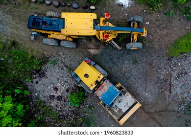 A Dirty Roadroller Parked Alongside The Road