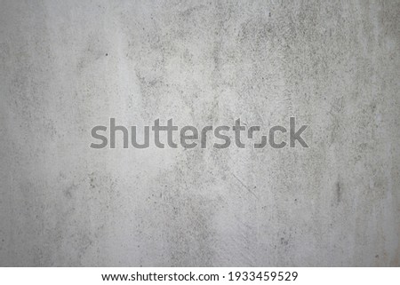 Dirty rough surface texture of sand screed cement wall with uneven stains and tiny holes.
