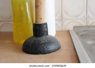 Dirty rubber plunger on wooden surface