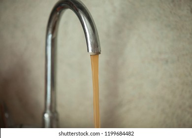 Dirty, Rusty Water Flows From The Tap