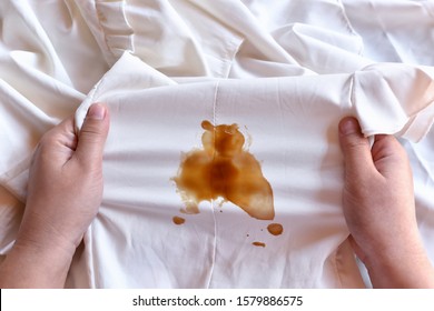 Dirty sauce stain on fabric from accident in daily life. Concept of cleaning stains on clothes or cleaning the house. Selected focus - Shutterstock ID 1579886575