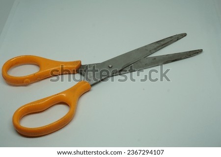Dirty scissors, marked by signs of use, set against a clean white background. These well-worn scissors bear the traces of their utility and craftsmanship.