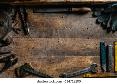 Dirty set of hand tools on a wooden background. Old rusty tools. Equipment for locksmith and metalworking shop. Sales tools for assembly workers. Old shop