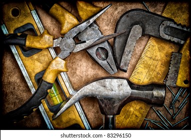 Dirty Set Of Hand Tools On A Wooden Panel