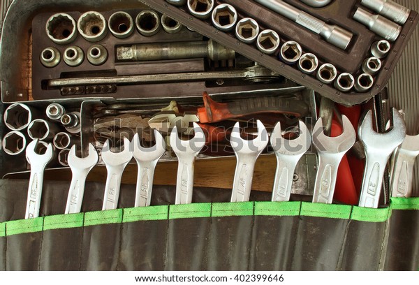Dirty set of hand tools on a vintage background.\
Tools and wrench. Many old wrench and tools close-up in box. Tool\
to repair the car or replace automotive spare parts, auto parts.\
Dirty tool service