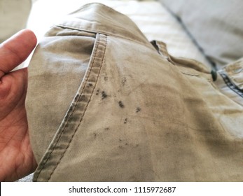 Dirty shorts in hand. Oil stain or grease stain on clothes.  - Shutterstock ID 1115972687