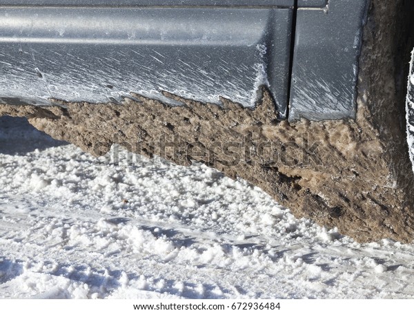  dirty snow adhered to the car while driving on the\
winter road