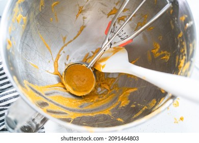 Dirty Spatula And Dough Scoop In Metal Mixing Bowl.