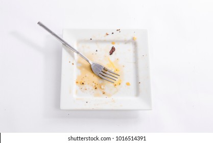Dirty square plate with a fork