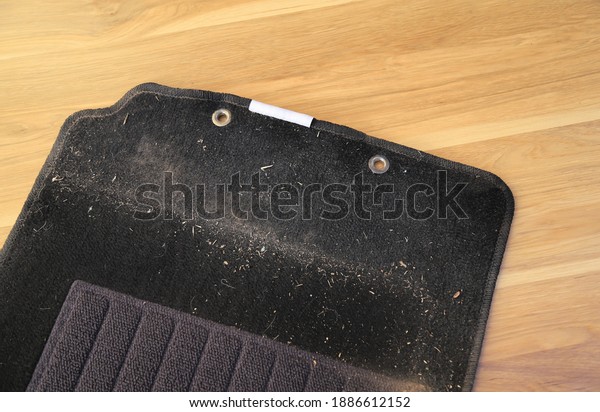 dirty stain from dust on carpet of car on wooden\
table for cleaning before using it. dirt stains for cleaning and\
washing in daily life concept\
