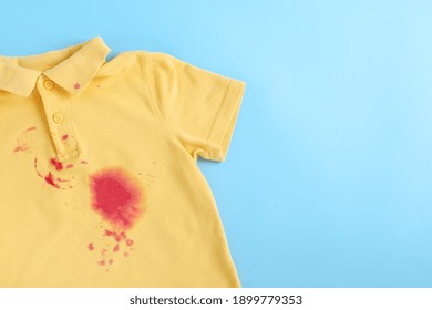 dirty stain on clothes. isolated on blue background. space for text. High quality photo - Shutterstock ID 1899779353