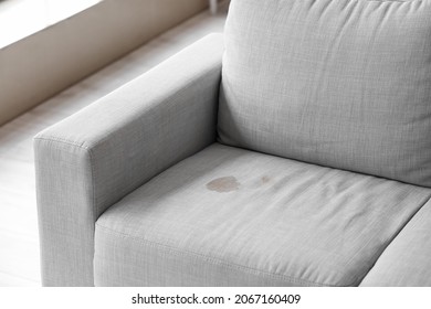 Dirty stain on grey sofa in living room - Shutterstock ID 2067160409