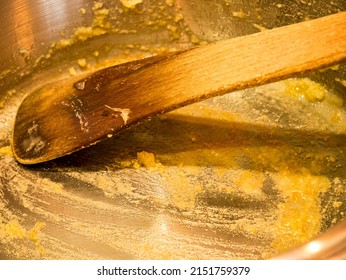 Dirty Stainless Steel Pan With Wooden Spoon