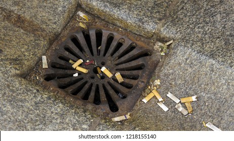 Dirty Storm Drain Clogged With Cigarette Butts.