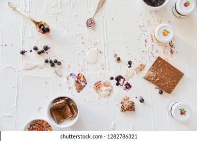 Dirty Table After Cooking And Eating Ice Cream: Drops, Sprinkles, Berries. The Concept Of Mess, Dirty Dishes.