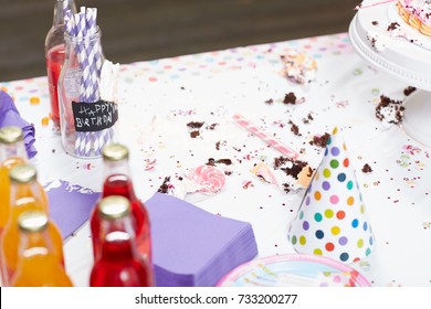 Dirty Tablecloth On Messy Table With Cake Scraps After Birthday Party