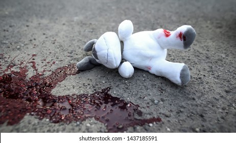 Dirty Toy Dog Lying On Road Near Blood Stain, Terrible Car Accident With Victims