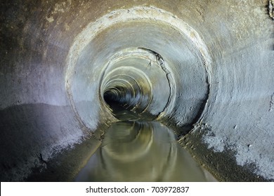 Dirty urban sewage flowing throw round sewer tunnel pipe 