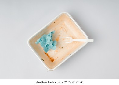 Dirty Used Container With Fork And Napkin After Eating On White Background