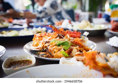 Dirty Waste Food And Used Napkin On Plate After Eating Seafood Party In The Restaurant.