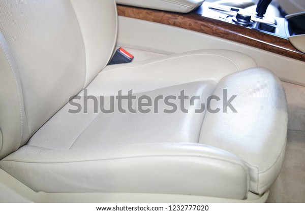 a dirty white car seat and clean the seat after the\
car wash