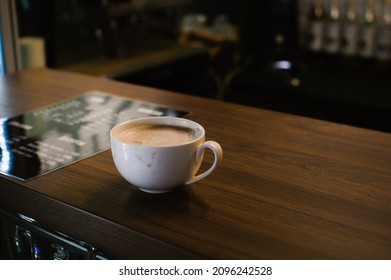 Dirty White Coffee Cup Stands On The Wooden Counter Of A Coffee Shop