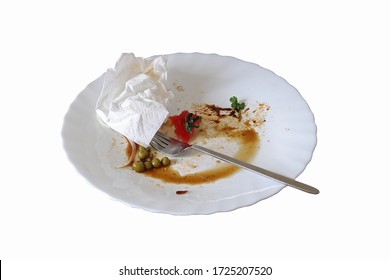 Dirty White Plate With Leftovers Used Crumpled White Napkin And Dirty Metal Fork On The Indoor Table Selective Focus White Background Isolated