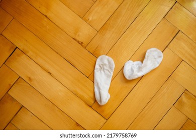 Dirty White Socks On A Wooden Floor