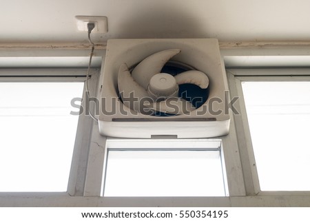 Dirty white ventilation fan at the toilet windows