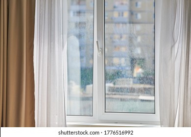 Dirty window in apartment. Unwashed dusty glass, city street view background. Unclean double glazed window