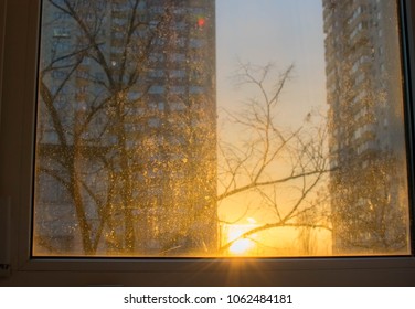 dirty window with rays of the setting sun