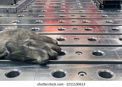 Dirty Work Gloves Of A Welder Left On The Welding Table Close-up