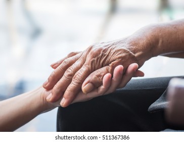 Disability Awareness Day, Aging Society Concept With Parkinson Disease,  Alzheimer Patient, Elderly Senior Citizen Person's Hand With Arthritis Pain In Nursing Family Care Giving Of Caregiver Support