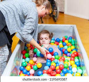 Disability A Disabled Child Enjoying Play Therapy Together With A Special Needs Carer