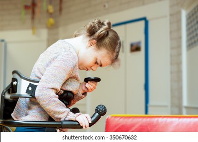 Disability A Disabled Child In A Walking Aid Exploring Her Surroundings / Disability A Disabled Child Exploring Her Surroundings