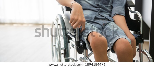 Disability polio patient sitting on wheelchair in\
hospital, Banner with copy\
space